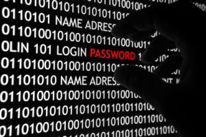 image of hacker's hand stealing a password from a computer